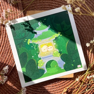 May include: A hand-painted illustration of a small, moss-covered pagoda with two cute characters inside. The pagoda is glowing with a warm light and surrounded by lush green foliage.