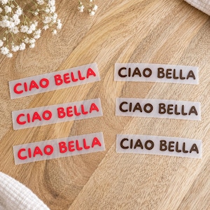 May include: Six rectangular adhesive labels arranged in two columns. The left column features three labels with the text "CIAO BELLA" in bright red, while the right column features three labels with the text "CIAO BELLA" in dark brown.