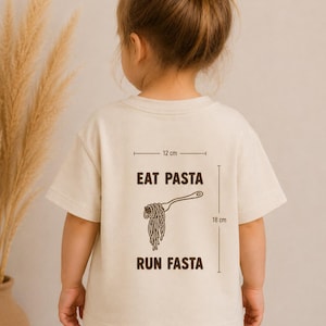 May include: A cream-coloured t-shirt with the text "EAT PASTA RUN FASTA" and a graphic of pasta on a fork. The graphic is 18 cm tall and 12 cm wide. The shirt is worn by a child.