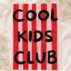 May include: A rectangular print featuring vertical stripes in alternating shades of red and light pink. The text COOL KIDS CLUB is printed in large, bold, black, rounded capital letters across the centre of the striped background.