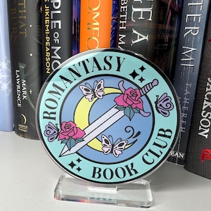 May include: A round, blue and white book club sign with a sword, flowers, and butterflies. The sign says "Romance Fantasy Book Club".
