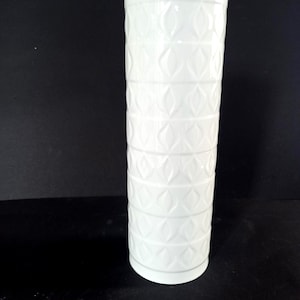 May include: A set of three ceramic mugs with a speckled, matte finish. The mugs are in shades of cream, light gray, and dark gray. Each mug has a simple, minimalist design, perfect for coffee or tea.