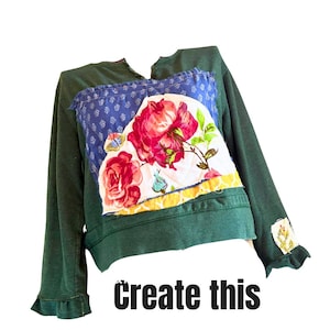 May include: Dark green sweatshirt with floral patchwork detail. The patchwork features a blue patterned fabric and a white fabric with red roses and butterflies. The text "create this" is printed in black at the bottom.