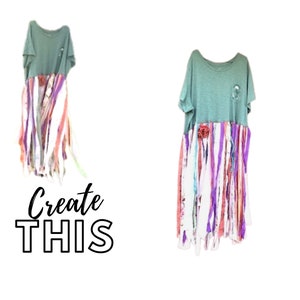 May include: A light green t-shirt with a long, colourful, frayed skirt attached. The skirt is made of strips of fabric in various shades of pink, purple, white, and blue. The text "Create This" is written in black below the image.