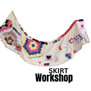 May include: A curved, off-white fabric skirt featuring a patchwork design with various colorful patterns, including floral prints, geometric shapes, and heart motifs. The text SKIRT Workshop is printed in black below the garment.