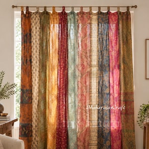May include: A set of tab-top curtains featuring vertical panels in various colours including orange, yellow, red, blue, and pink, with diverse floral and geometric patterns. The fabric is semi-sheer, and the text MaharajasCraft is visible.