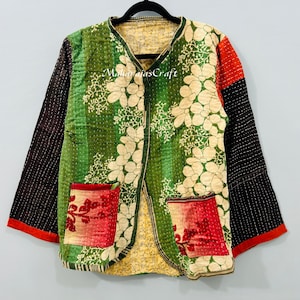 May include: A reversible jacket with a floral pattern and two pockets. The jacket features a green base with white floral designs, red and black sleeves, and a yellow lining. The text "Maharajas Craft" is visible on the jacket.