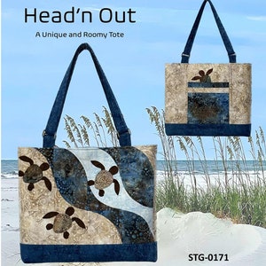 May include: A tote bag with a beach theme, featuring three appliqued sea turtles swimming in a wavy pattern of beige and blue fabrics. The bag has dark blue handles and a matching base. The text "Head'n Out" and "A Unique and Roomy Tote" are visible.