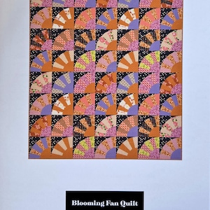 May include: A colorful quilt with a fan pattern, featuring orange, pink, purple, and black accents. The quilt is titled "Blooming Fan Quilt" and has the designer's name at the top.