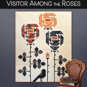 May include: A quilt pattern titled Visitor Among the Roses by Robin Pickens Quilt Patterns. The quilt features a cream background with three stylized rose blossoms in orange and black floral prints, black stems, leaves, and a black bird silhouette.