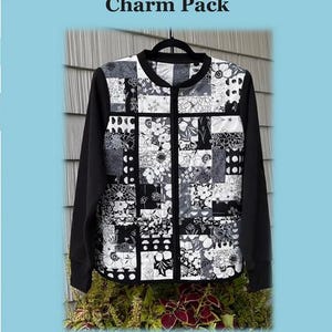 May include: A black and white quilted sweatshirt jacket with a floral patchwork design. The jacket has black sleeves and a full-length zipper. The text "Charm Pack" and "Quilted Sweatshirt Jacket" are visible.