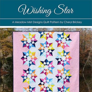 May include: A quilt pattern titled "Wishing Star" by Cheryl Brickey. The quilt features a pink background with colorful starburst designs in shades of blue, yellow, orange, and pink. The text "Meadow Mist designs" is at the bottom.