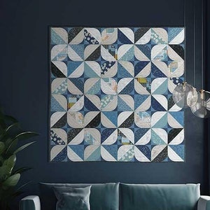 May include: A blue and white quilt pattern with the title "Zen Chic Lotus" by Brigitte Heitland. The quilt is displayed on a dark blue wall above a teal blue sofa and a black coffee table.