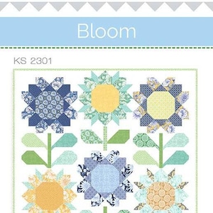 May include: A quilting pattern featuring a floral design with blue, yellow and green fabric. The pattern is titled "Bloom" and has the product code "KS 2301".