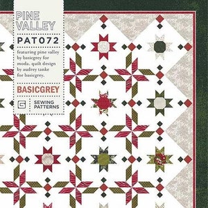 May include: A quilt pattern featuring a repeating pattern of red, green and white stars. The pattern is called "Pine Valley" and is part of the "BasicGrey" sewing pattern collection. The pattern number is "PAT072".