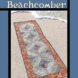 May include: A quilt pattern cover titled "Beachcomber" featuring a rectangular quilt design with a beach theme. The quilt has a central pattern of blue, white, and tan shapes, framed by a border of starfish and a sandy background.