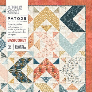 May include: A quilt pattern called "Apple Seed" by BasicGrey featuring a geometric design with a variety of floral and patterned fabrics in shades of blue, green, yellow, orange, and pink.