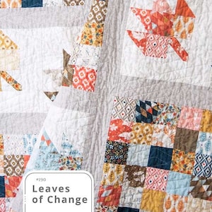 May include: A quilt pattern featuring a patchwork design with a variety of colors and patterns, including orange, blue, yellow, and brown. The quilt is titled "Leaves of Change" and is part of the "Nella Boutique" pattern collection.