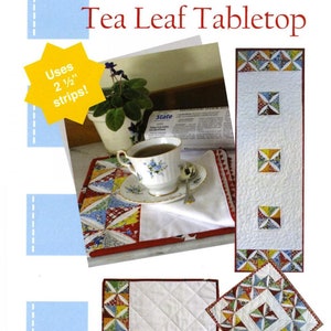 May include: A quilting pattern for a tea leaf tabletop, placemats, and table toppers. The pattern uses 2 1/2 inch strips and features a red, white, and blue color scheme. The pattern is called "Tea Leaf Tabletop" and is from Poor House Quilt Designs.