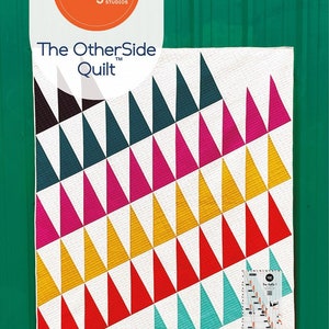 May include: A quilt pattern called "The Other Side Quilt" by Latifah Saafir Studios. The quilt is made of colorful triangles in shades of red, pink, yellow, teal, and black. The pattern requires the HuRTY 1 ruler and makes quilts in six sizes.