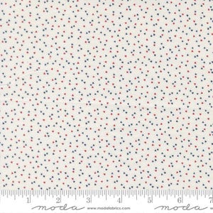 May include: Off-white fabric with a repeating pattern of small red and navy blue triangles. The fabric has a ruler along the bottom edge, with the word "moda" printed on it.