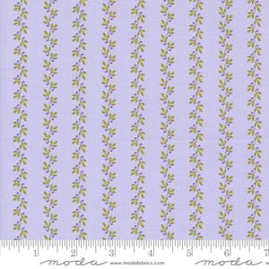 May include: Purple fabric with a repeating pattern of green vines and purple berries. The fabric has a white ruler with markings in inches.