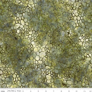 May include: A fabric with a mottled pattern of various sized, rounded shapes in shades of green, yellow, and gray. The design resembles a collection of pebbles or stones. The fabric is likely cotton or a similar material.
