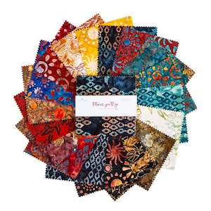 May include: A circular arrangement of colorful fabric squares. The squares feature various patterns in shades of red, blue, yellow, and green. A white label with the text "Places you'll go" is in the center. The fabric appears to be batik or hand-dyed.