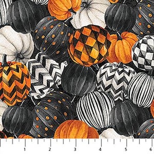 May include: A fabric pattern with pumpkins in black, white, and orange. The pumpkins have diverse patterns like stripes, polka dots, and zigzags. The background is black, and a ruler is at the bottom, with measurements in inches.