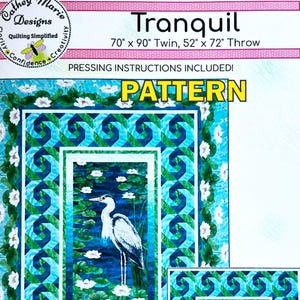 May include: A quilt pattern titled "Tranquil" with a heron in a pond design. The pattern includes pressing instructions and is available in twin (70" x 90") and throw (52" x 72") sizes. The design features shades of blue, green, and white.