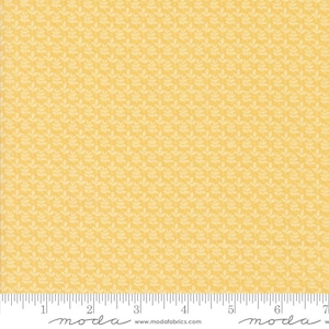 May include: A yellow fabric with a white repeating pattern of small leaves. The fabric is textured and has a subtle sheen. The fabric is labeled "moda" in the bottom left corner and "moda" in the bottom right corner.