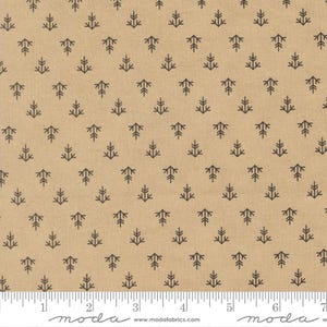 May include: A tan fabric featuring a repeating pattern of small, dark grey tree-like shapes. The fabric is measured with a ruler in centimetres, showing a grid pattern. The fabric has a natural, textured appearance.