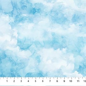 May include: A fabric with a watercolor-style cloud design in shades of light blue and white. The fabric is measured with a ruler showing inches, with a total width of 12 inches.