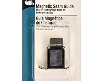 May include: A Dritz magnetic seam guide for sewing machines. The package includes the text "Magnetic Seam Guide" and "Guía Magnética de Costuras". The guide is designed to attach to the metal throat plate of a sewing machine.