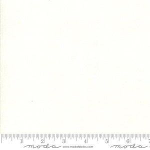 May include: A plain white fabric swatch with a ruler showing 7 inches. The ruler has the word "moda" printed on it.