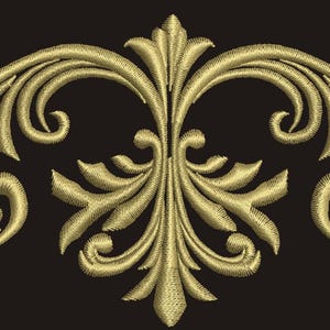 May include: A gold-colored decorative design with intricate swirls and flourishes. The design is symmetrical and has a central motif with two smaller motifs on either side.