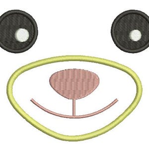 May include: An embroidered design of a cartoon animal face. The face features two black eyes with white highlights, a yellow oval nose outline, a pink nose, and a smiling mouth. Gray whiskers extend from the sides.