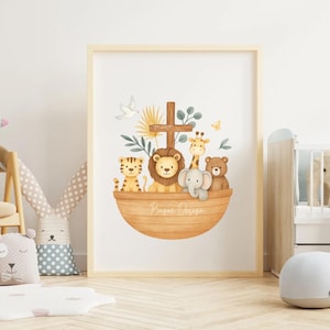 May include: A framed watercolor print featuring a wooden ark filled with cartoon animals: a tiger, lion, giraffe, elephant, and bear. A cross and dove are above the ark. The print has a light wood frame and the words "Basac Design" are on the ark.