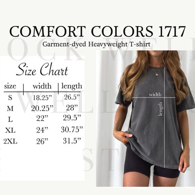 May include: A dark gray Comfort Colors 1717 garment-dyed heavyweight t-shirt. The image includes a size chart with measurements in inches for sizes S through 2XL. A person is wearing the t-shirt. The shirt's width ranges from 18.25" to 26" and the length from 26.5" to 31.5".