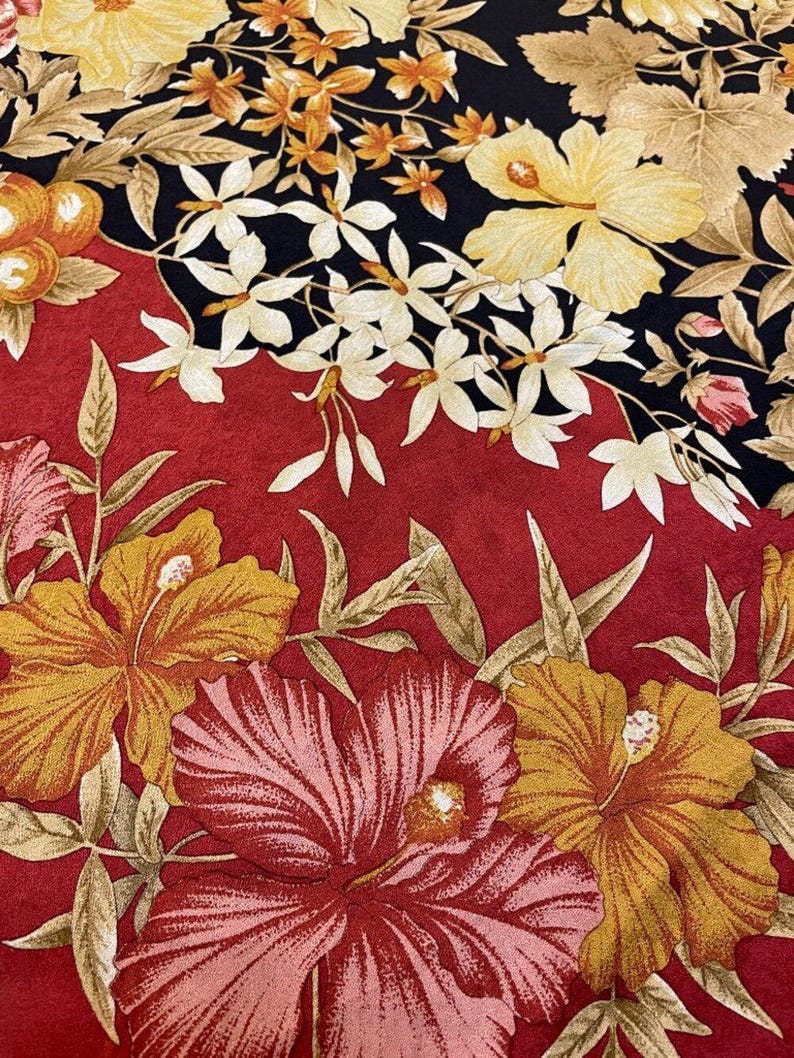 May include: A colourful floral design with large hibiscus flowers in red, pink, and yellow against a red and black backdrop. The pattern includes smaller white flowers and orange fruit, creating a tropical theme.