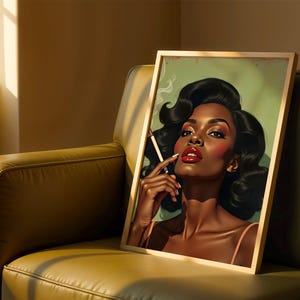 May include: A framed art print depicting a woman with dark hair, red lipstick, and a cigarette. The artwork has a vintage style, with a green backdrop and a gold frame. The print is displayed on a green leather armchair.