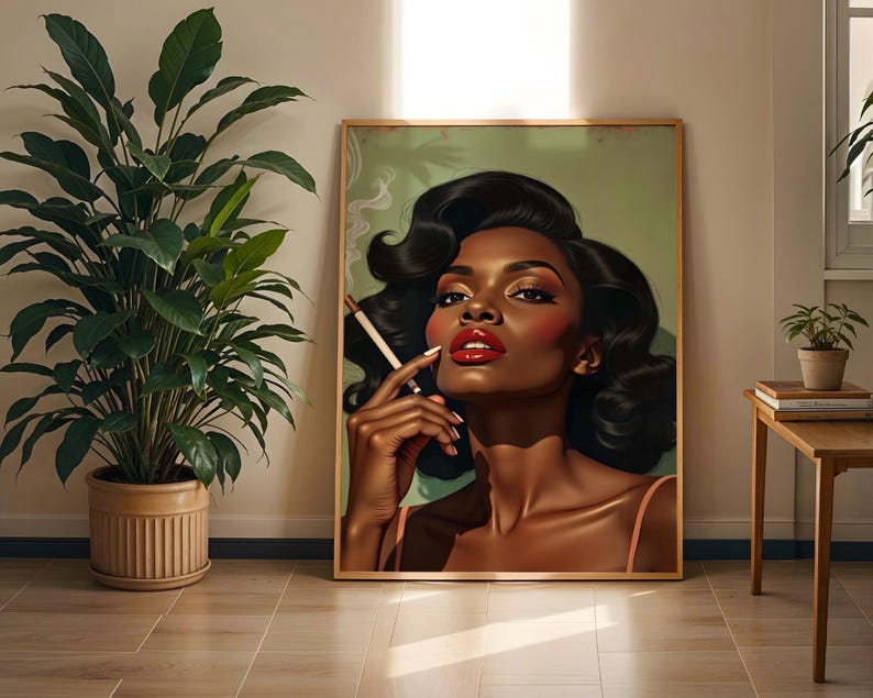 May include: A framed art print depicting a woman with dark skin, red lipstick, and black hair holding a cigarette. The artwork has a vintage aesthetic, with a soft green background and a wooden frame. The woman is wearing a light pink top.