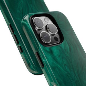 May include: A green phone case with a marbled design. The case has a raised camera bump with three lenses.