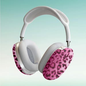 May include: White headphones with a pink leopard print design on the earcups.