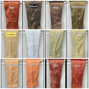 May include: A collection of tailored pants in various colors, including rust, black, purple, and golden brown. Other colors include golden, silver, and shades of green, peach, and red. Each pair features a detailed floral pattern.