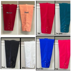 May include: A collection of eight pairs of women's trousers in various colors, including maroon, peach, red, sea green, black, white, royal blue, and pink. Each pair features a buttoned detail at the ankle. The colors are labeled with text.