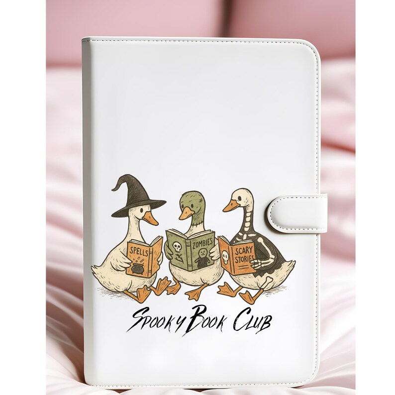 May include: White tablet case with a cartoon illustration of three ducks reading books. The books are titled "Spells", "Zombies", and "Scary Stories". The ducks are in Halloween costumes. The text "Spooky Book Club" is below the illustration.