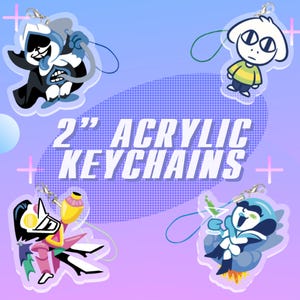 May include: Four acrylic keychains featuring cartoon characters, each with a different design and color scheme. The keychains are 2 inches in size and have a clear background with a purple and blue gradient.