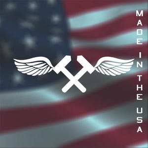 May include: White logo featuring two crossed hammers with wings, set against a blurred American flag background. The text "MADE IN THE USA" is vertically aligned on the right side of the image.