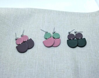 May include: Three pairs of earrings with a geometric design. The earrings are made of polymer clay and feature a combination of green, pink, and brown colors.